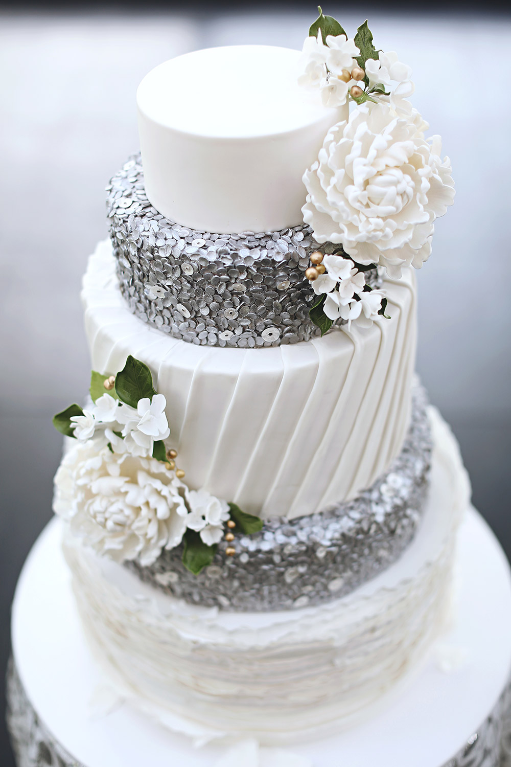 White and silver wedding cake by Miss Shortcakes. Photo by Axioo. www.theweddingnotebook.com
